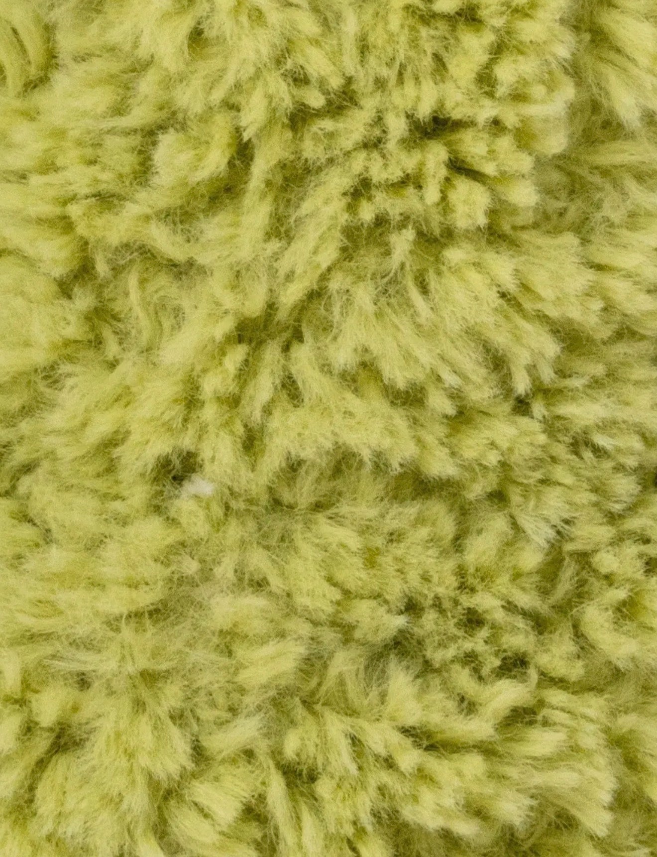 Close-up van de limoengroene vacht van de Retro Vrienden Kikker knuffel