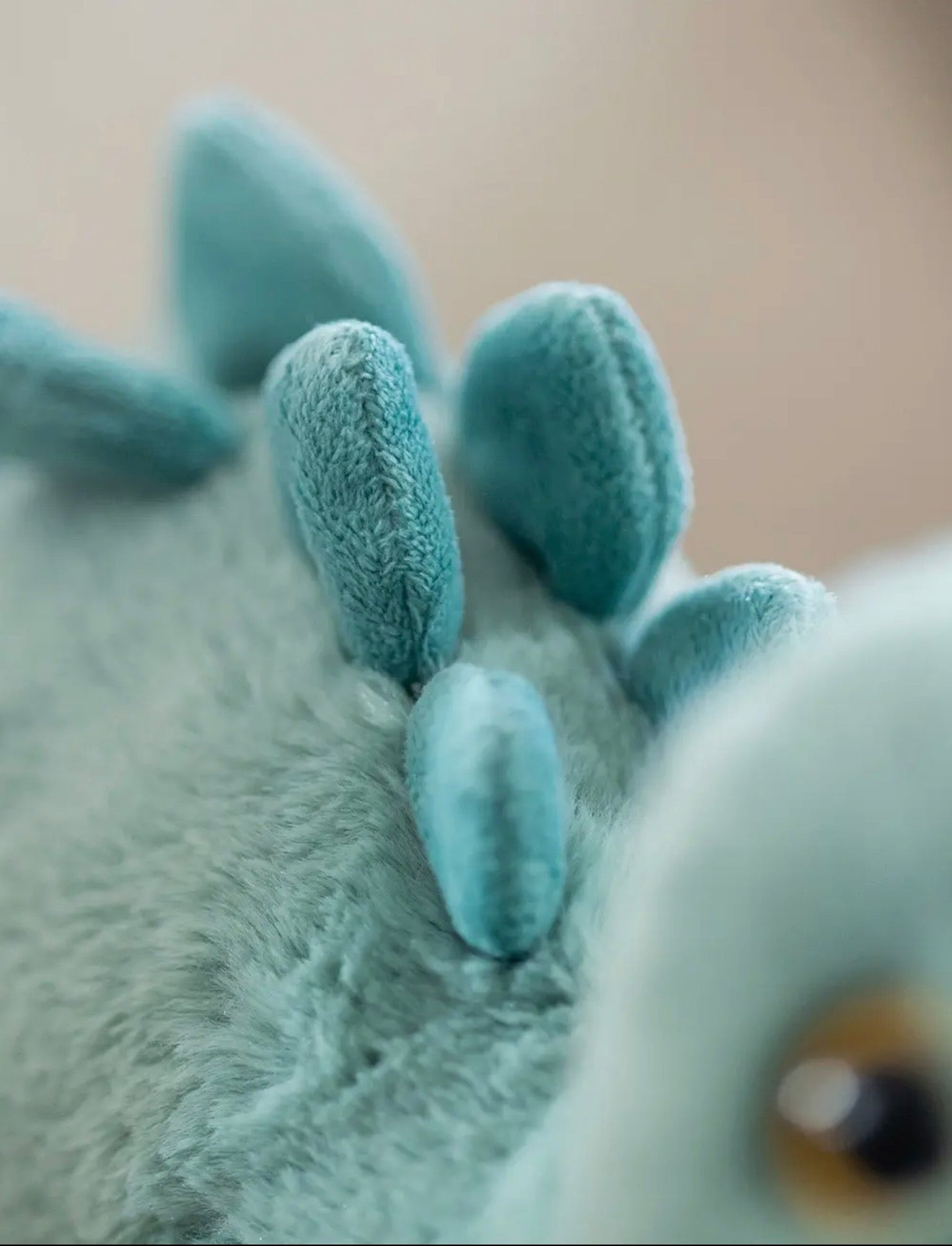 Close-up van de saliegroene ruggenplaten van de Pluche Stegosaurus knuffel